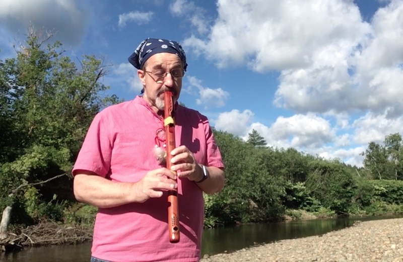 Playing the Native American Flute by a stream